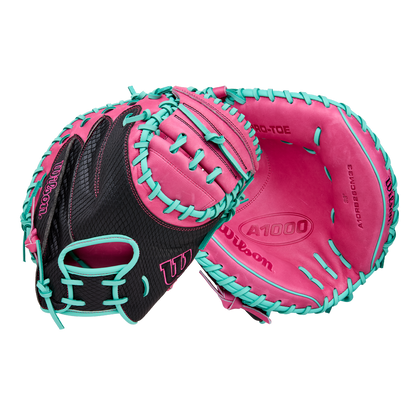 The Wilson A1000 CM33 33" Baseball Catcher's Mitt (WBW10396633) by Wilson features a black design with bright pink palm and teal blue lacing, crafted from full grain leather—ideal for youth catchers. Shown front and back on white background.