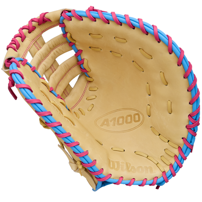 A Wilson A1000 1620 12.5" Baseball First Base Mitt (WBW103967125) by Wilson, shown open with palm and webbing visible against a white background, features full grain leather and blue and pink laces.