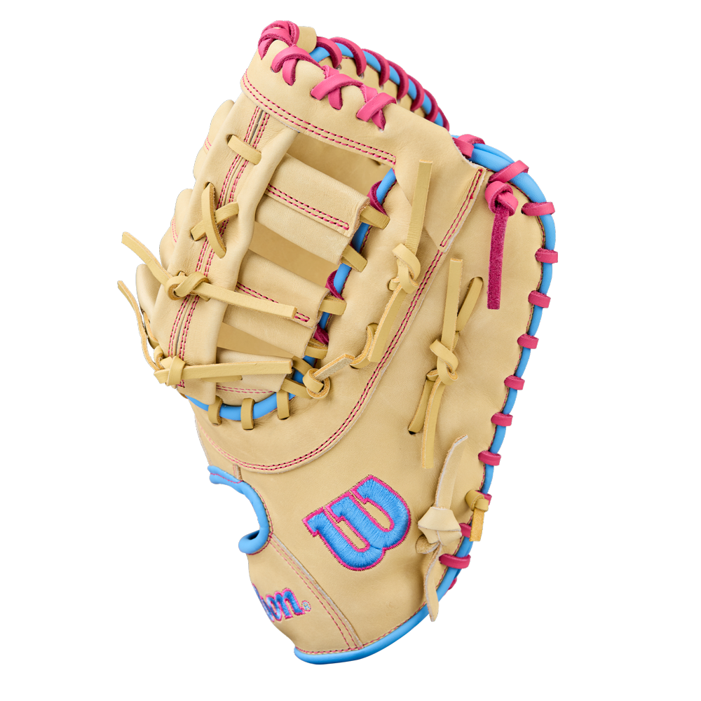 The Wilson A1000 1620 12.5" Baseball First Base Mitt (WBW103967125) is a tan youth glove made of full grain leather with pink and blue laces and a blue Wilson W logo outlined in pink on the thumb, shown on a white background.