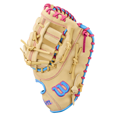 The Wilson A1000 1620 12.5" Baseball First Base Mitt (WBW103967125) is a tan youth glove made of full grain leather with pink and blue laces and a blue Wilson W logo outlined in pink on the thumb, shown on a white background.