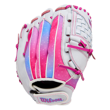 The Wilson Flash 11.5" Fastpitch Glove (WBW103985115) features a white design with pink, purple, and blue accents, pink laces, Wilson embroidered on the wrist strap, a woven web, and a gradient color pattern on the back.