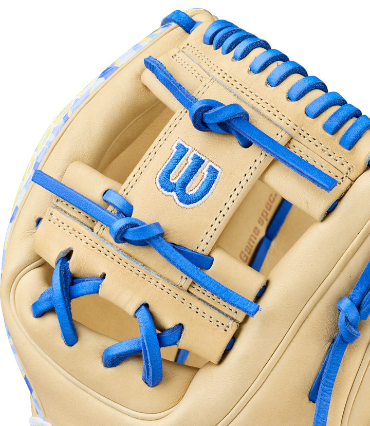 Close-up of the Wilson A2000 BWJ7 11.75" Bobby Witt Jr. GM Baseball Glove (WBW1040681175) in beige, featuring bright blue laces, a stitched W on the back, and detailed Pro Stock leather texture.