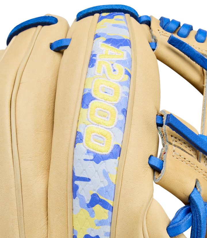 Close-up of the Wilson A2000 BWJ7 11.75" Bobby Witt Jr. GM Baseball Glove (WBW1040681175), featuring tan Pro Stock leather, blue laces, a blue/yellow/gray camo strip, and yellow “A2000” embroidery for infielders.