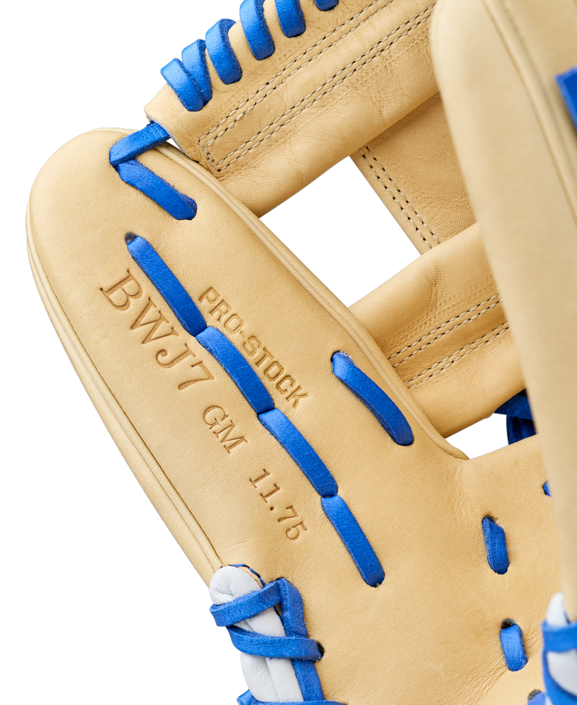 Close-up of the Wilson A2000 BWJ7 11.75" Bobby Witt Jr. GM Baseball Glove (WBW1040681175) with blue laces, Pro Stock leather, and "BWJ7 GM 11.75" and "PRO STOCK" embossed, showcasing fine stitching and leather texture.