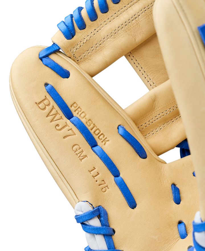 Close-up of the Wilson A2000 BWJ7 11.75" Bobby Witt Jr. GM Baseball Glove (WBW1040681175) with blue laces, Pro Stock leather, and "BWJ7 GM 11.75" and "PRO STOCK" embossed, showcasing fine stitching and leather texture.