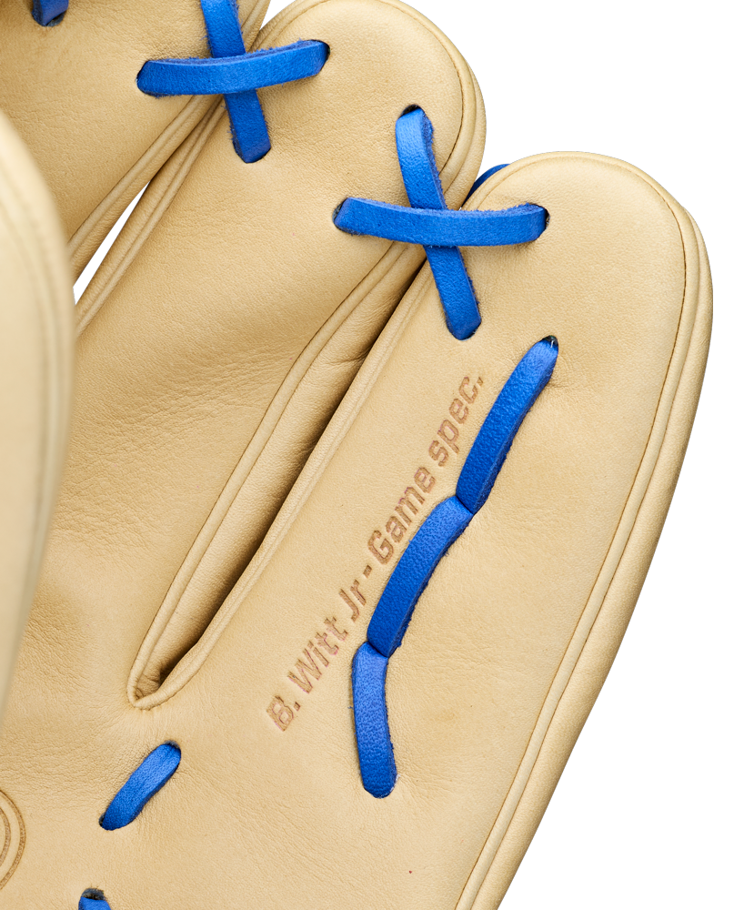 A close-up of a tan Wilson A2000 BWJ7 11.75" Bobby Witt Jr. GM baseball glove with blue laces, featuring "B. Witt Jr. Game Spec." stamped near the base of the fingers. Model: WBW1040681175.