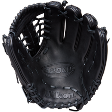 A black Wilson A2000 1789 11.5" baseball glove (WBW104106115) with visible stitching and lacing is photographed from above, showing the palm and webbing. The Wilson brand is embossed on premium Pro Stock leather.