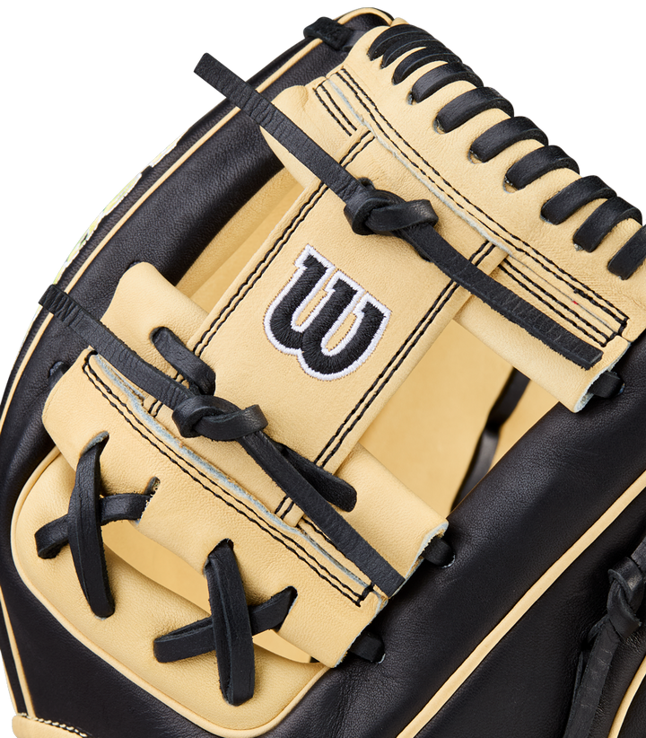 Close-up of the Wilson A2000 1786 11.5" Baseball Glove, featuring Pro Stock Leather in beige and black, detailed stitching, black laces, H-Web design, and a white “W” logo embroidered on the back.