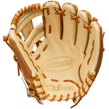 A Wilson A2000 1786 11.5" infield glove, crafted from Pro Stock Leather in tan and brown, is shown palm-side with visible stitching, laces, and an embossed Wilson logo inside.