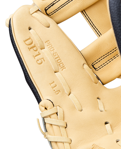 Close-up of the Wilson A2000 DP15SS 11.5" baseball glove (WBW104110115) featuring tan leather, black laces, detailed stitching, embossed "DP15 PRO STOCK 11.5" text, and Pedroia Fit Technology for a secure, comfortable fit.