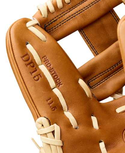 Close-up of the Wilson A2000 DP15 11.5" Baseball Glove (WBW104111115) by Wilson, featuring cream laces, tan Pro Stock leather with DP15 and 11.5 embossed, Pedroia Fit design, and detailed visible stitching.