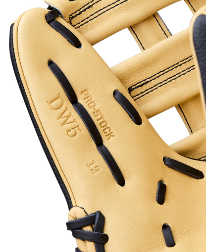 Close-up of a Wilson A2000 DW5 12" Baseball Glove (model WBW10411612) in tan with black laces, featuring "PRO STOCK," "DW5," and "12" embossed on the Pro Stock Leather near the pocket.