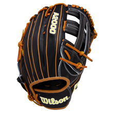A black Wilson A2000 1750 12.5" Baseball Glove (WBW104121125) with tan laces and white stitching is displayed at an angle on a white background. The Wilson logo appears on the wrist strap, and the model number is stitched on the back.