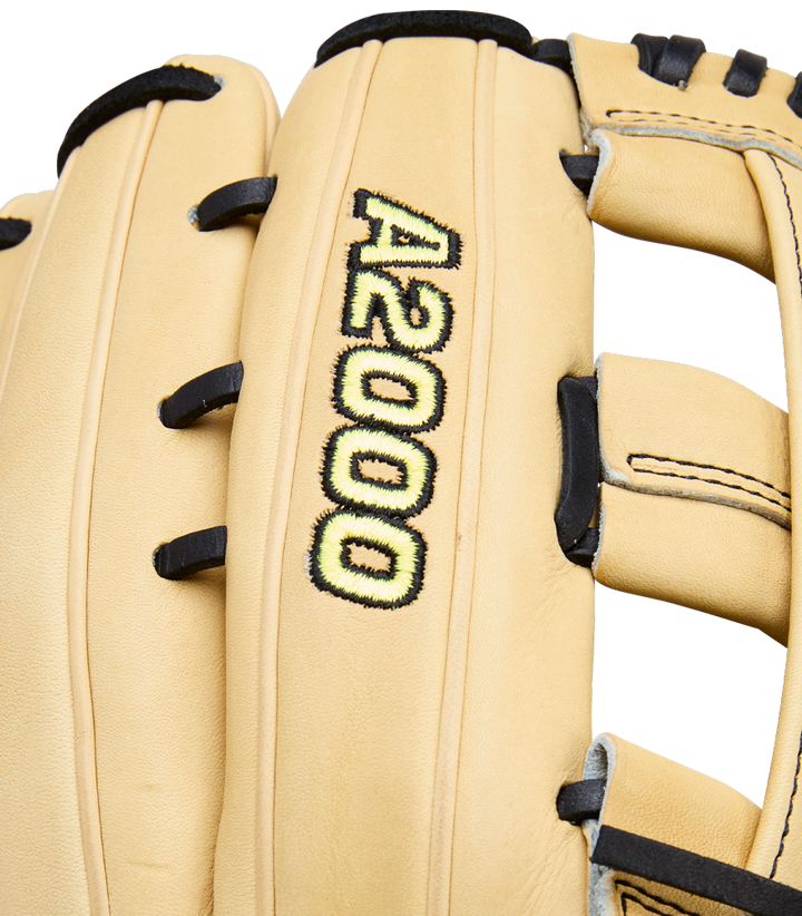 A close-up of the Wilson A2000 1777 12.75" Baseball Glove (WBW1041231275) shows its tan Pro Stock leather, black laces, and A2000 logo embroidered in yellow and black on the back, highlighting Wilson’s premium outfield glove design.