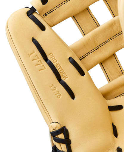 Close-up of a Wilson A2000 1777 12.75" Baseball Glove (WBW1041231275) outfield glove in tan with black laces. Stamped text reads 1777, Pro Stock, and 12.75 on the Pro Stock Leather; stitching and texture are clearly visible.