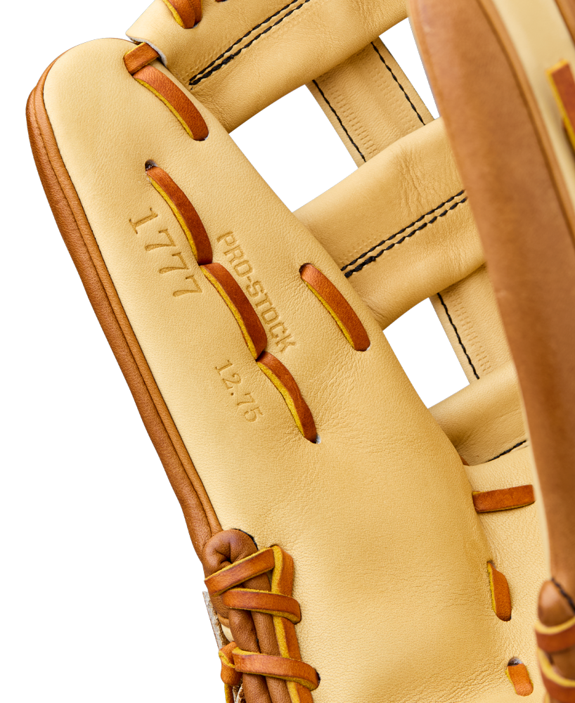 Close-up of the Wilson A2000 1777 12.75" Baseball Glove featuring tan Pro Stock Leather, visible stitching, and laces. The inner palm displays "1777," "PRO STOCK," and "12.75," highlighting its premium Wilson craftsmanship.