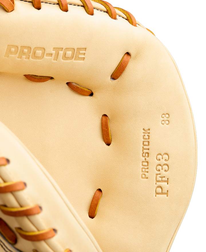 Close-up of a tan Wilson A2000 PF33 33" Baseball Catcher's Mitt (WBW10412733) with brown leather lacing, featuring PRO-TOE and PRO-STOCK PF33 33" stamped on the inside.