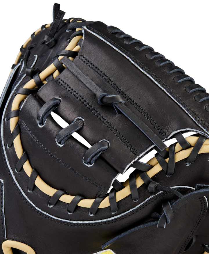 Close-up of the Wilson A2000 1734 34" Baseball Catcher's Mitt (WBW10412834), crafted from black Pro Stock Leather with tan laces and white stitching, highlighting its detailed craftsmanship and woven web.