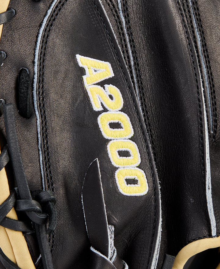 Close-up of a Wilson A2000 1734 34" Baseball Catcher's Mitt (WBW10412834) in black Pro Stock Leather, featuring "A2000" stitched in yellow and white, with cream laces visible on the glove’s left side.
