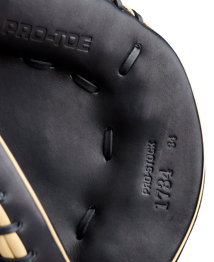 Close-up of the Wilson A2000 1734 34" Catcher's Mitt (WBW10412834) in black, showing detailed stitching and embossed text, highlighting Wilson’s authentic Pro Stock Leather craftsmanship.