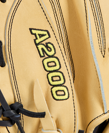Close-up of a tan Wilson A2000 1734 34" Baseball Catcher's Mitt (WBW10412934) with black laces and A2000 stitched in yellow and black on the surface.