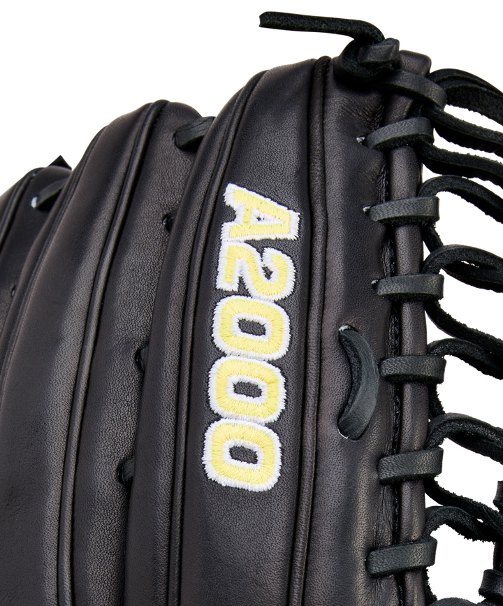 Close-up of a black Wilson A2000 OT7 12.75" Baseball Glove (WBW1041811275) featuring "A2000" embroidered in yellow and white near the laces.