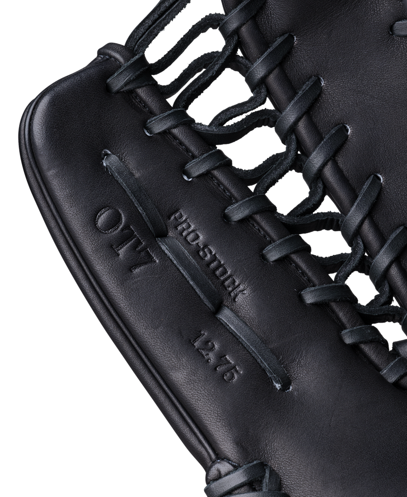 Close-up of a black Wilson A2000 OT7 12.75" Baseball Glove (WBW1041811275), highlighting its laces and embossed text reading “PRO STOCK,” “OT7,” and “12.75.”.