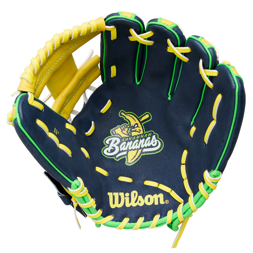The Wilson A450 Savannah Bananas 11" Youth Baseball Glove (WBW10419211) features navy blue color, yellow and green laces, a cartoon banana with a bat, "Bananas" embroidery on the palm, and a classic H-Web design.