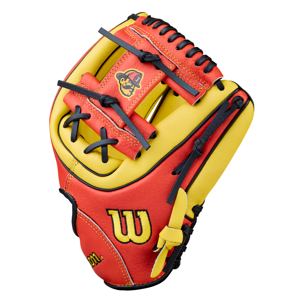 A red and yellow Wilson youth baseball glove with black laces is shown upright. Featuring a small cartoon mascot and the yellow W Wilson logo, this glove boasts a classic Wilson H-Web design ideal for young players.