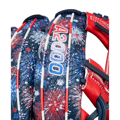 Close-up of the Wilson A2000 1975SS 11.75" Baseball Glove (GOTM July 2025), featuring a red, white, and blue fireworks pattern, white laces, and "A2000" stitched in blue and white on the back.