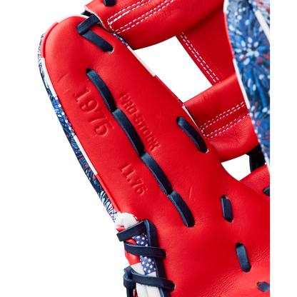 Close-up of the Wilson A2000 1975SS 11.75" Baseball Glove (GOTM July 2025) featuring red Pro Stock leather, navy blue and white laces, embossed "PROEDITION," "1975," and "11.75" on the inner palm, with patterned blue edges.