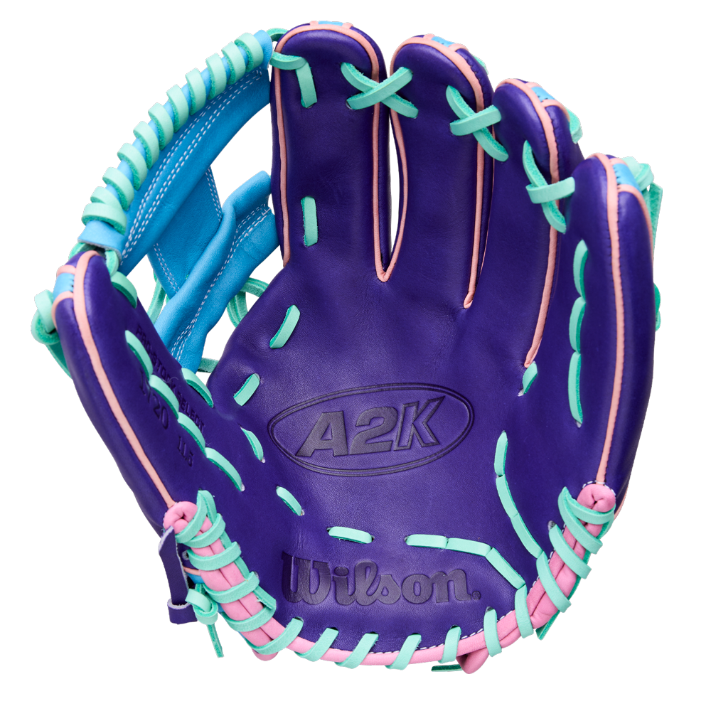 The Wilson A2K 1720 11.5" GOTM October 2025 baseball glove (WBW104220115) features a purple design with light blue and pink lacing, Pro Stock Select leather, and is shown palm forward on a white background.