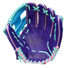 The Wilson A2K 1720 11.5" GOTM October 2025 baseball glove (WBW104220115) features a purple design with light blue and pink lacing, Pro Stock Select leather, and is shown palm forward on a white background.