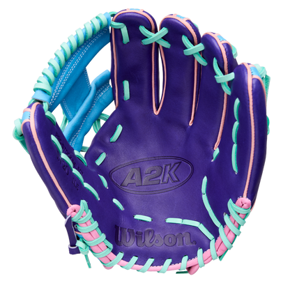 The Wilson A2K 1720 11.5" GOTM October 2025 baseball glove (WBW104220115) features a purple design with light blue and pink lacing, Pro Stock Select leather, and is shown palm forward on a white background.