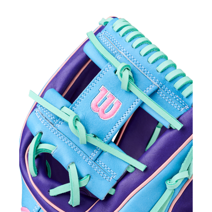 Close-up of the Wilson A2K 1720 11.5" GOTM October 2025 Baseball Glove, showcasing blue, purple, and teal Pro Stock Select leather with green laces and a pink-embroidered W logo on a blue patch.