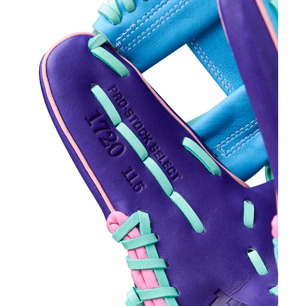 Close-up of a Wilson A2K 1720 11.5" GOTM October 2025 Baseball Glove, featuring purple with teal, blue, and pink laces. Crafted from Pro Stock Select leather, it's stamped PRO STOCK SELECT, 1720, and 11.5 on the palm.