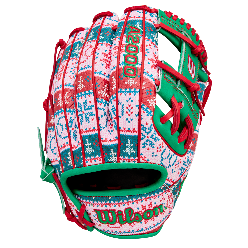 The Wilson A2000 1975 11.75" Baseball Glove (GOTM December 2025) features a festive red, green, and white holiday sweater pattern with bright “A2000” and “Wilson” stitching.