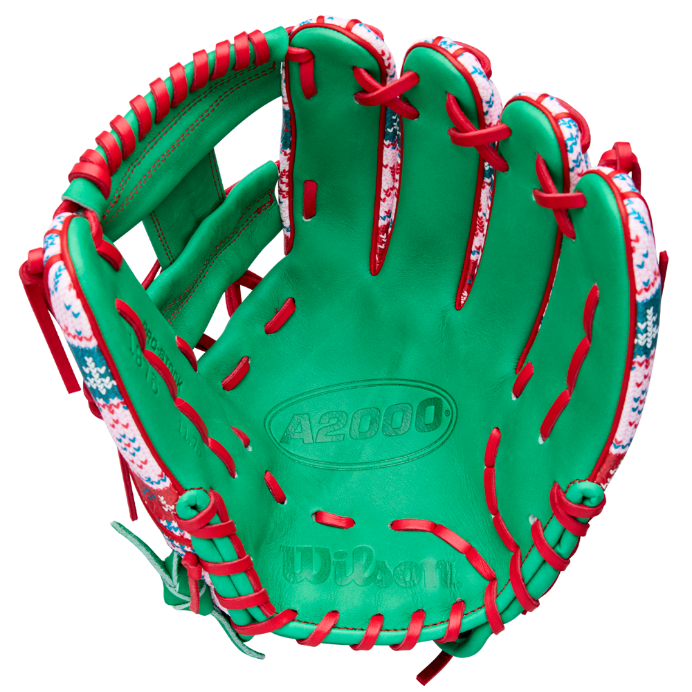 The Wilson A2000 1975 11.75" Baseball Glove - GOTM December 2025 features green Pro Stock leather, red laces, and a festive snowflake and holiday pattern along the edges for a unique holiday design.