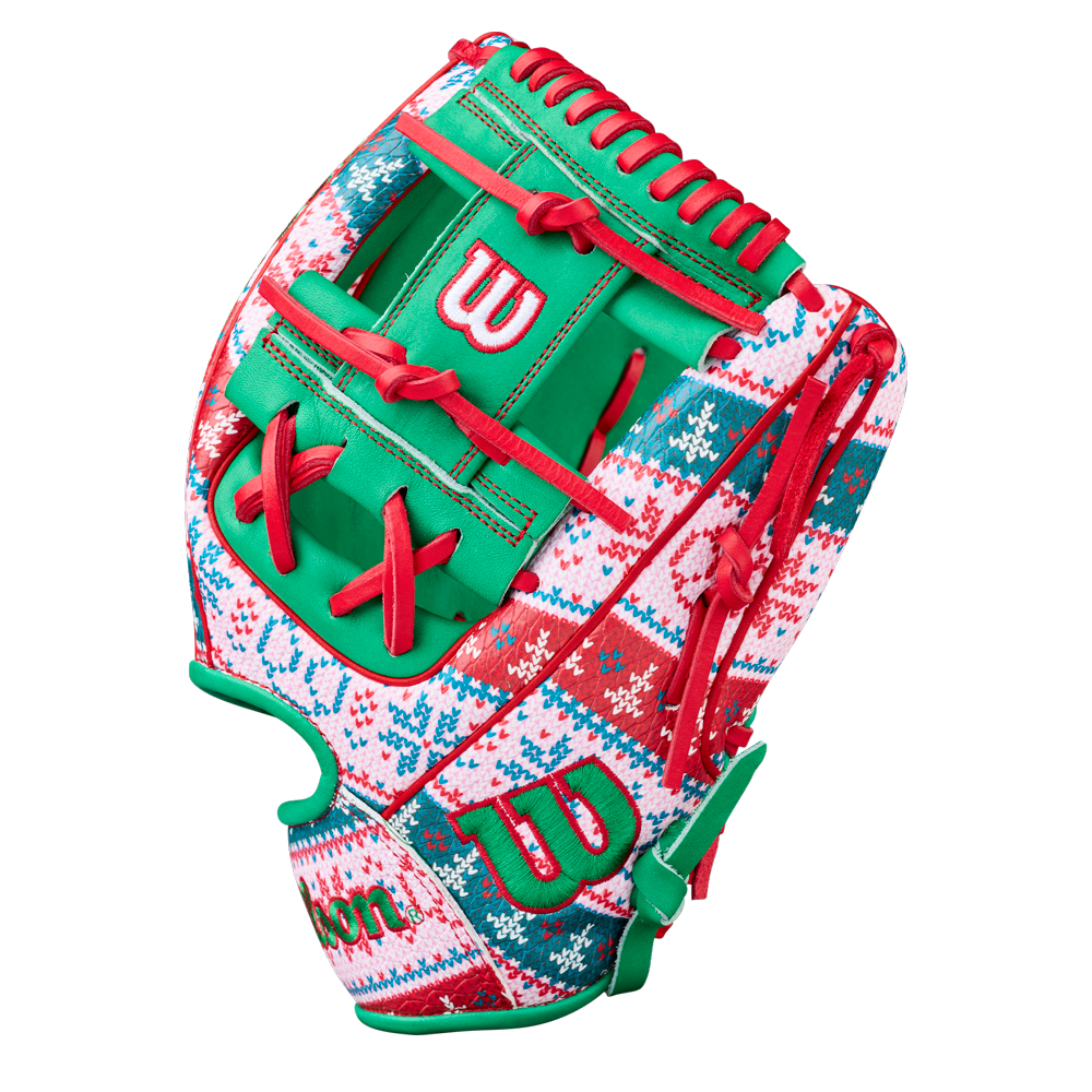 The Wilson A2000 1975 11.75" Baseball Glove - GOTM December 2025 features festive red, green, and white colors with snowflakes and zigzags, red laces, green accents, and premium Pro Stock leather for great performance.