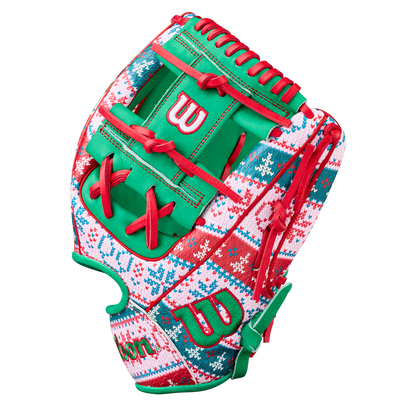 The Wilson A2000 1975 11.75" Baseball Glove - GOTM December 2025 features festive red, green, and white colors with snowflakes and zigzags, red laces, green accents, and premium Pro Stock leather for great performance.