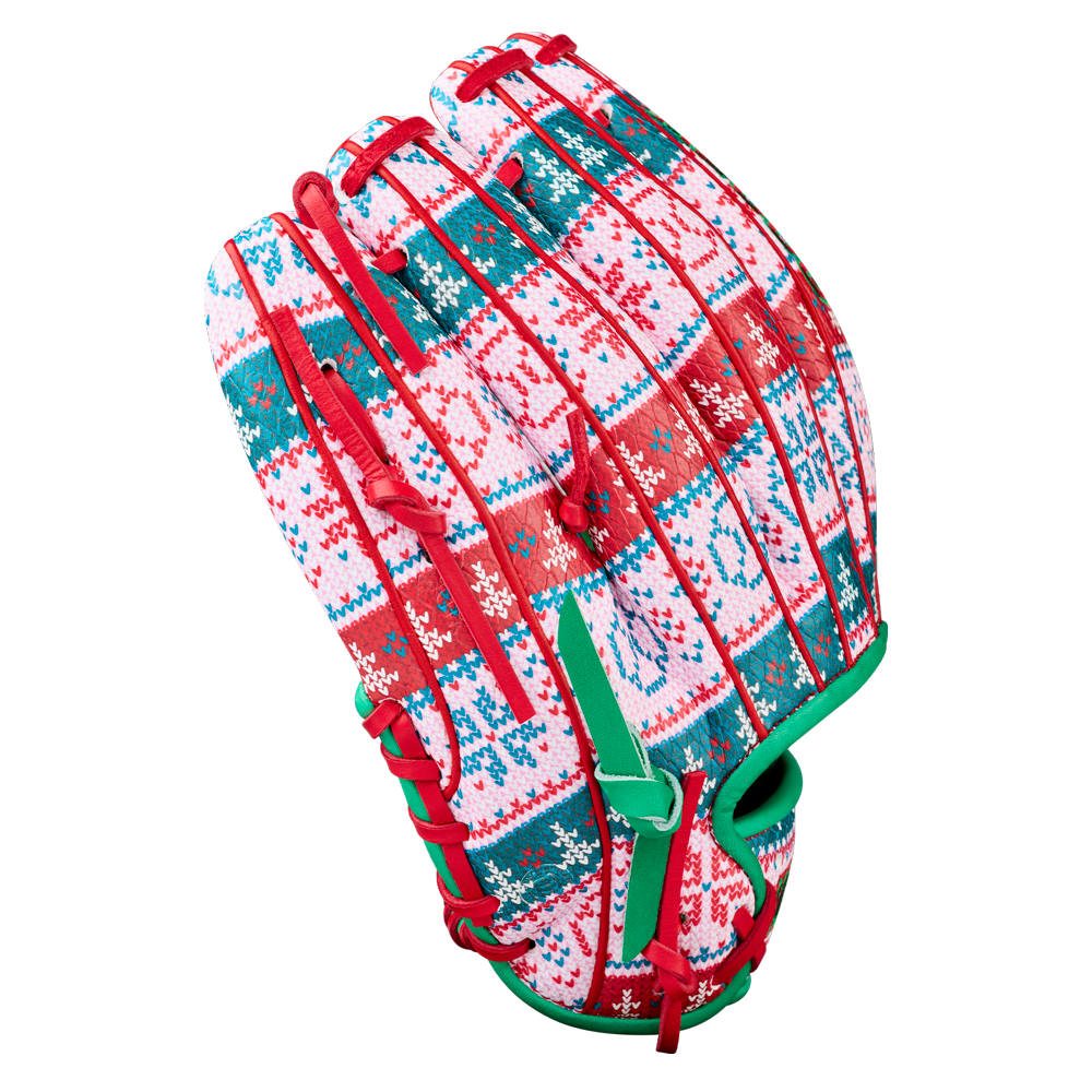 The Wilson A2000 1975 11.75" Baseball Glove (GOTM December 2025) features a festive red, green, and white holiday pattern with snowflakes and geometric designs, red laces, green trim, and Pro Stock leather for premium performance.