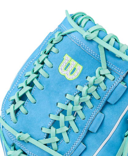 Close-up of the Wilson A2000 FPHG 12" Fastpitch Glove (WBW10423512): light blue with turquoise laces, white stitching, and a neon green/white W logo near the thumb. Made from Pro Stock leather for premium performance.