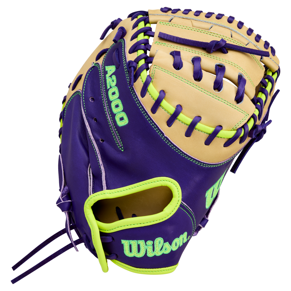 The Wilson A2000 FPCM23 34" fastpitch catcher's mitt features tan and purple Pro Stock leather with neon green accents, stitching, and bold Wilson logo. Model: WBW10423934.