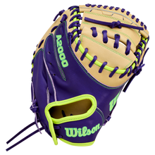 The Wilson A2000 FPCM23 34" fastpitch catcher's mitt features tan and purple Pro Stock leather with neon green accents, stitching, and bold Wilson logo. Model: WBW10423934.