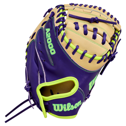 The Wilson A2000 FPCM23 34" fastpitch catcher's mitt features tan and purple Pro Stock leather with neon green accents, stitching, and bold Wilson logo. Model: WBW10423934.