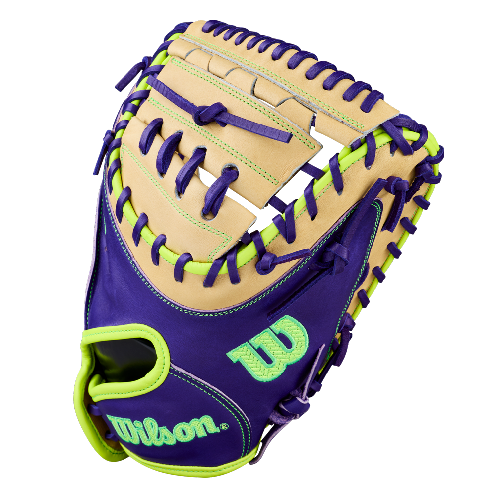 The Wilson A2000 FPCM23 34" Fastpitch Catcher’s Mitt features premium Pro Stock leather in tan with purple accents, bright green laces, and open web. Wilson’s logo stands out in bright green and teal, with colorful stitching for a bold look.