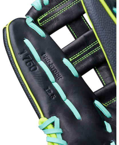Close-up of the Wilson A2000 1750SS 12.5" Baseball Glove (WBW104599125) with bright green and teal laces, featuring PRO-STOCK 12.5 1750 embossing and detailed stitching on premium Pro Stock leather.