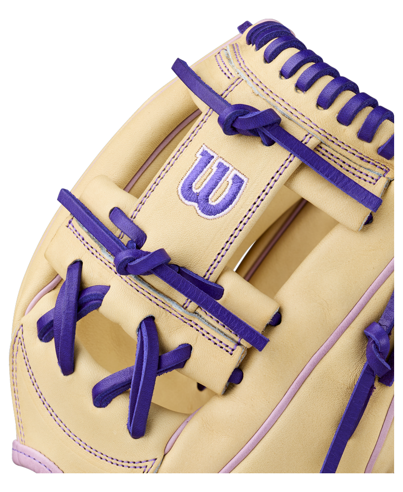 Close-up of the Wilson A2000 H12 12" Fastpitch Glove (WBW10460712) in beige, with purple laces and stitching, made from Pro Stock Leather and featuring the Wilson W logo in purple and white.