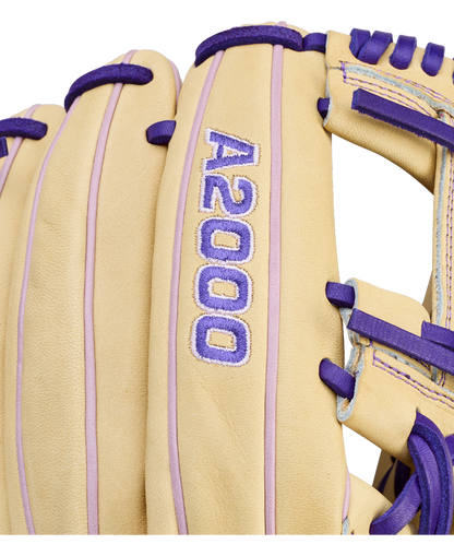 Close-up of a tan Wilson A2000 H12 12" Fastpitch Glove (WBW10460712) with purple laces and stitching, made from premium Pro Stock Leather. Features embroidered "A2000" in purple and white.