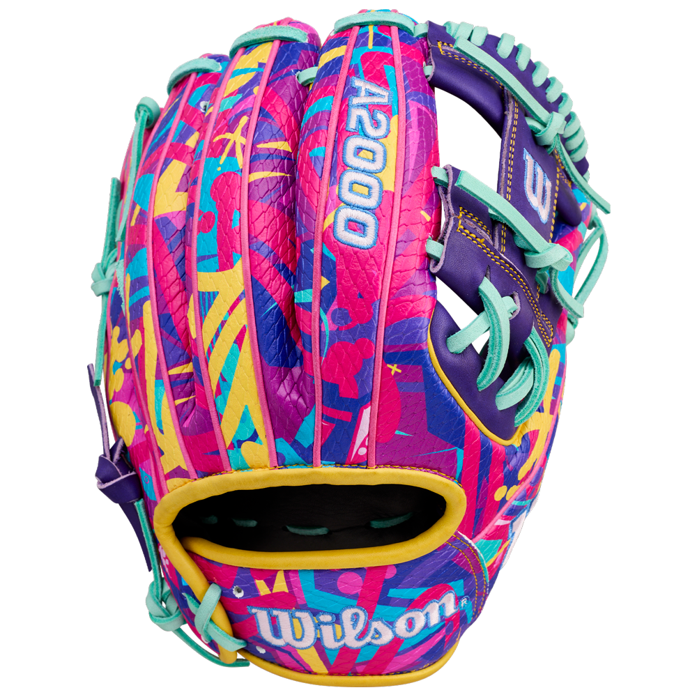 The Wilson A2000 1786SS 11.5" GOTM January 2026 baseball glove features bold abstract pink, yellow, teal, and purple patterns, teal lacing, durable SuperSkin material, and "A2000" and "Wilson" in white.